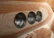 Metal sockets for flush mounting in a wooden house